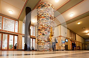 Student watching the unreal books tower in the Library