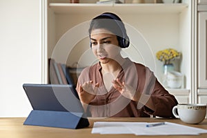 Student woman engaged in e-learning through videocall app on tablet