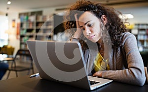 Student woman finding it difficult at study and comprehend scool tasks photo