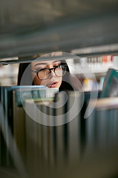 Student Woman Searching Books In Bookstore Or Library