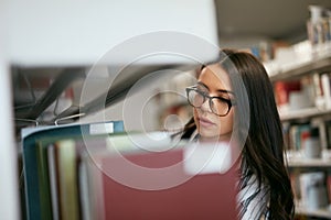 Student Woman Searching Books In Bookstore Or Library