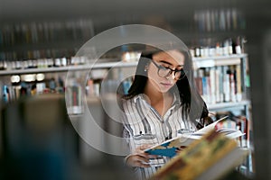 Student Woman Searching Books In Bookstore Or Library