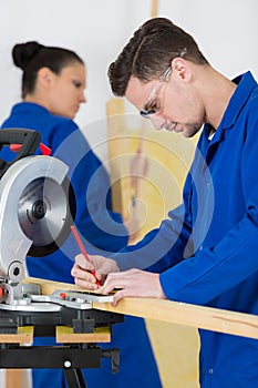 Student woodworking class learning to drill with nails