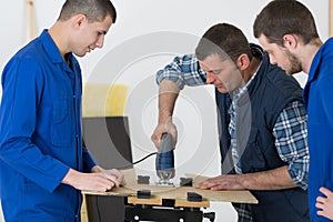 Student woodworking class learning to drill with nails
