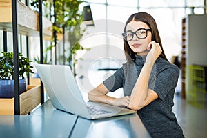 Student work process concept. Woman working university project with generic design laptop.