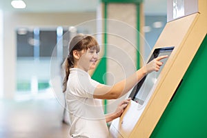 Student working on touch screen computer in school