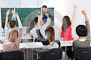 Students answering teacher in mathematics class