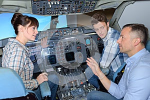 Students asking questions in aircraft cockpit