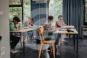 Students attentively listening to elderly professor in classroom setting