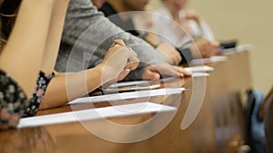 Students in auditorium - listening at conference or presentation, workshop, master class - notes and pens