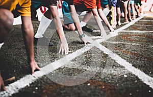 Students boy get set to leaving the starting for running competition boy at school sports day. photo