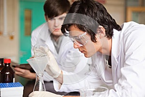 Students in chemistry making an experiment