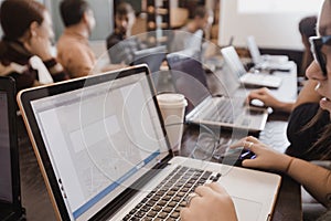 Students in classroom working with laptops