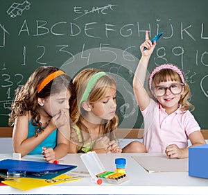 Students with clever children girl raising hand