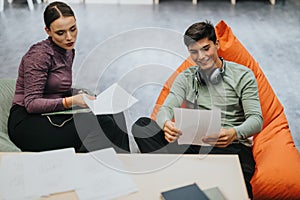 Students collaborating on a project in a modern school setting with focus and creativity.