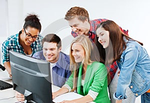 Students with computer studying at school