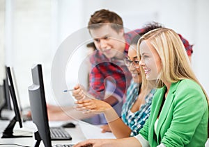Students with computer studying at school