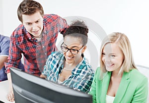 Students with computer studying at school