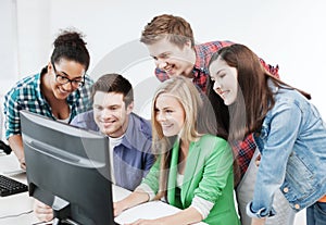 Students with computer studying at school