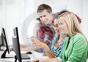 Students with computer studying at school