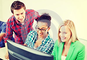 Students with computer studying at school