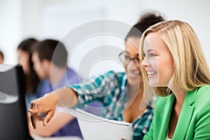 Students with computer studying at school