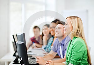 Students with computers studying at school