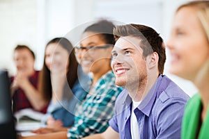 Students with computers studying at school
