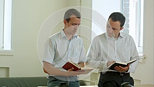 Students couple in school library have discussion about book