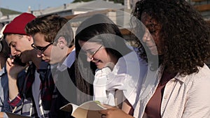 Students debate over their homework sitting near the univesity.