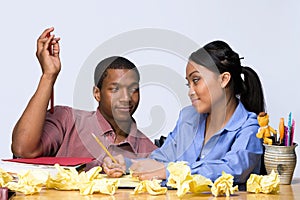 Students at Desk with Crumpled Paper - Horizontal