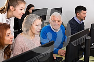 Students of different ages looking at monitor