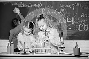 Students doing biology experiments with microscope. Little kids learning chemistry in school lab. Chemistry. Back to