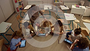 Students doing class work on digital tablets. Pupils using tablet computers