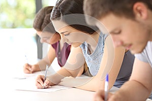 Students doing an exam in a classroom photo