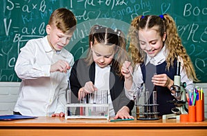 Students doing experiments with microscope. Chemistry. Back to school. happy childrens day. Little kids learning