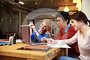 Students doing homework with laptop together