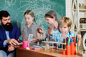 Students doing science experiments with microscope in lab. school kids scientist studying science. happy children