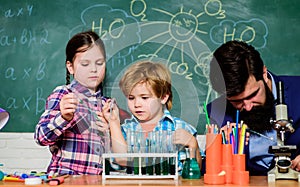 Students doing science experiments with microscope in lab. school kids scientist studying science. happy children