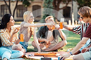 Students drinking juice and eating celebrating their graduation.