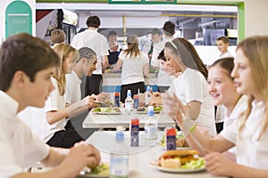Students eating in the school cafeteria photo