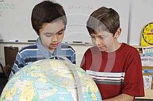Students Examining A Globe