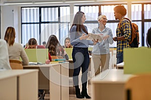 Students and female professor in discussion about the lesson