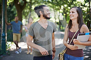 Students, friends and talking of college on campus for learning, knowledge and happy conversation. Young people laughing