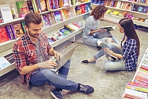 Students with gadget at the bookshop