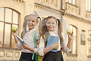 Students girls classmates with backpacks having school lunch, healthy life concept