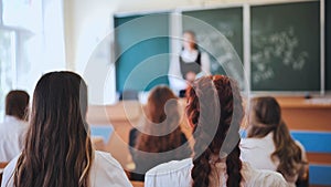 Students girls sitting in a class at school.