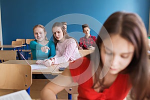 Students gossiping behind classmate back at school