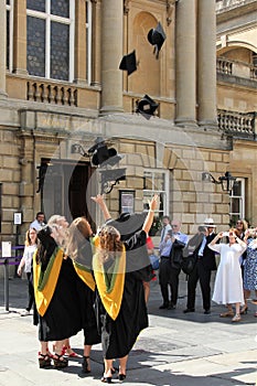 Graduates celebrating near the Roman Baths, Bath, England