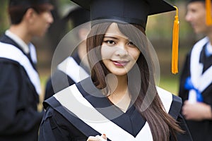 students in graduation gowns on university campus